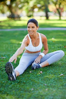 Buy stock photo Woman, runner and stretching in nature with earphones for music, fitness and ready for cardio in park. Warm up in grass, start run and listening to radio, sport and flexibility outdoor for exercise