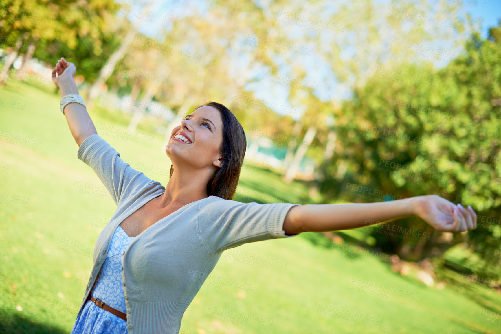 Buy stock photo Happy woman, freedom and park for outdoor wellness, travel and fresh air in green environment and summer. A young and casual person stretching her arms, celebration and excited with energy in nature