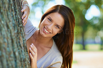 Buy stock photo Woman, enviroment and tree with smile, portrait and happiness with joy and green fun for nature. Lady, laugh and sun with grass, forest and bokeh for exited playful summer with optimism and sunshine