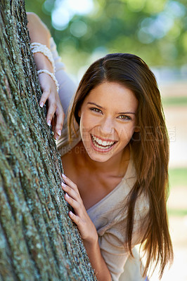 Buy stock photo Woman, lean and tree with smile, portrait and happiness with joy and green fun for nature. Lady, laugh and sun with grass, forest and bokeh for exited playful summer with optimism and sunshine