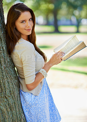 Buy stock photo Park, portrait and woman with smile for book, novel and fiction in nature to relax by tree outdoor. Adult, girl and female person with confidence for knowledge, happy and joy for reading in summer
