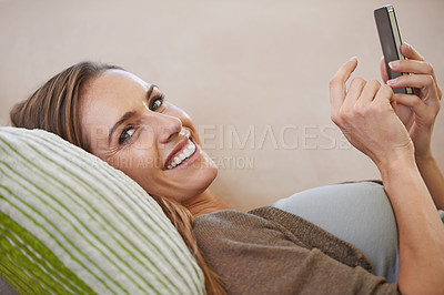 Buy stock photo Woman, portrait and cellphone texting on sofa for relaxing communication or internet browsing, search or living room. Female person, face and smartphone conversation in home or chat, message or smile