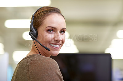 Buy stock photo An attractive female worker wearing a headset
