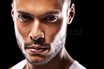 Buy stock photo Closeup studio portrait of a determined young sportsman against a black background