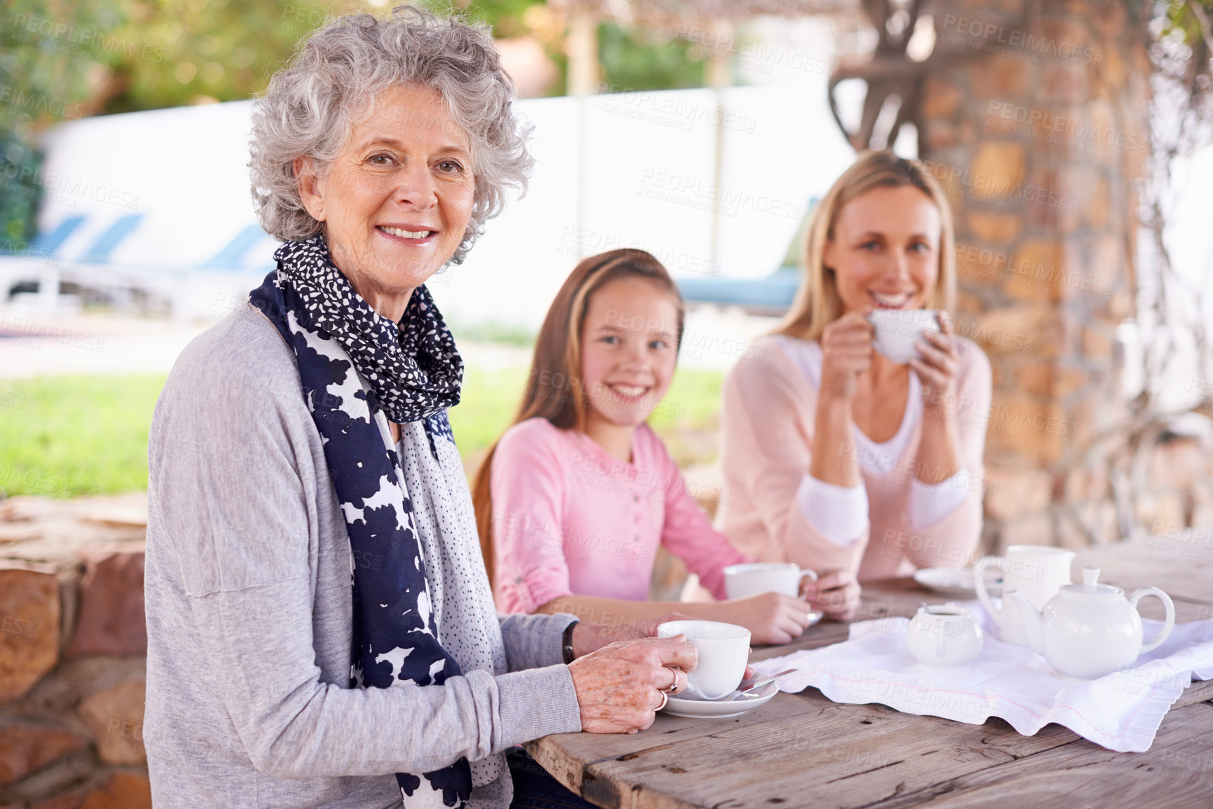 Buy stock photo Woman, child and relax with tea for fun, generations in park together for bonding with love. Family time, mother and happy grandma and smile for summer garden picnic, cups and teapot for beverage