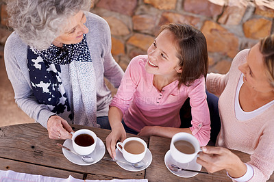 Buy stock photo Coffee, generations or women to visit, relax or drink hot beverage at picnic table as family hangout. Child, mama or pensioner at cafe in happy, retirement or fun as bonding together at weekend