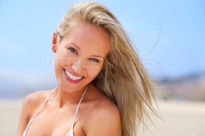 Buy stock photo Woman, portrait and smile at outdoor beach, travel and breeze for ocean holiday or summer vacation. Happy female person, wind and sun for weekend trip on sand, relax and confidence in outdoor nature