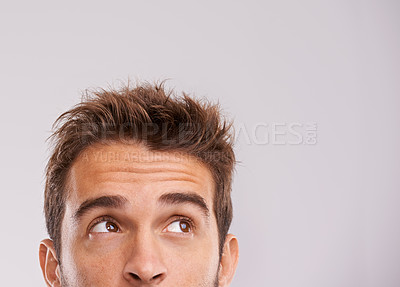 Buy stock photo Mockup, eyes up and man with thinking for information, promotion and presentation in studio. Male person, idea and vision on white background for inspiration, daydreaming or thoughtful direction
