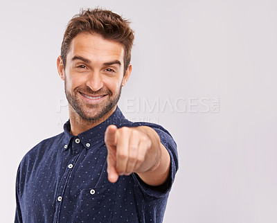 Buy stock photo A handsome young casually dress man pointing straight at the camera