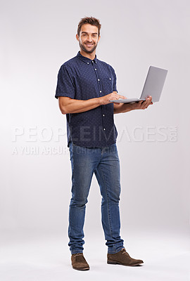 Buy stock photo Businessman, laptop and portrait in studio for connection and happy for digital planning on grey background. IT consultant, face and productivity on internet on website and online for web development