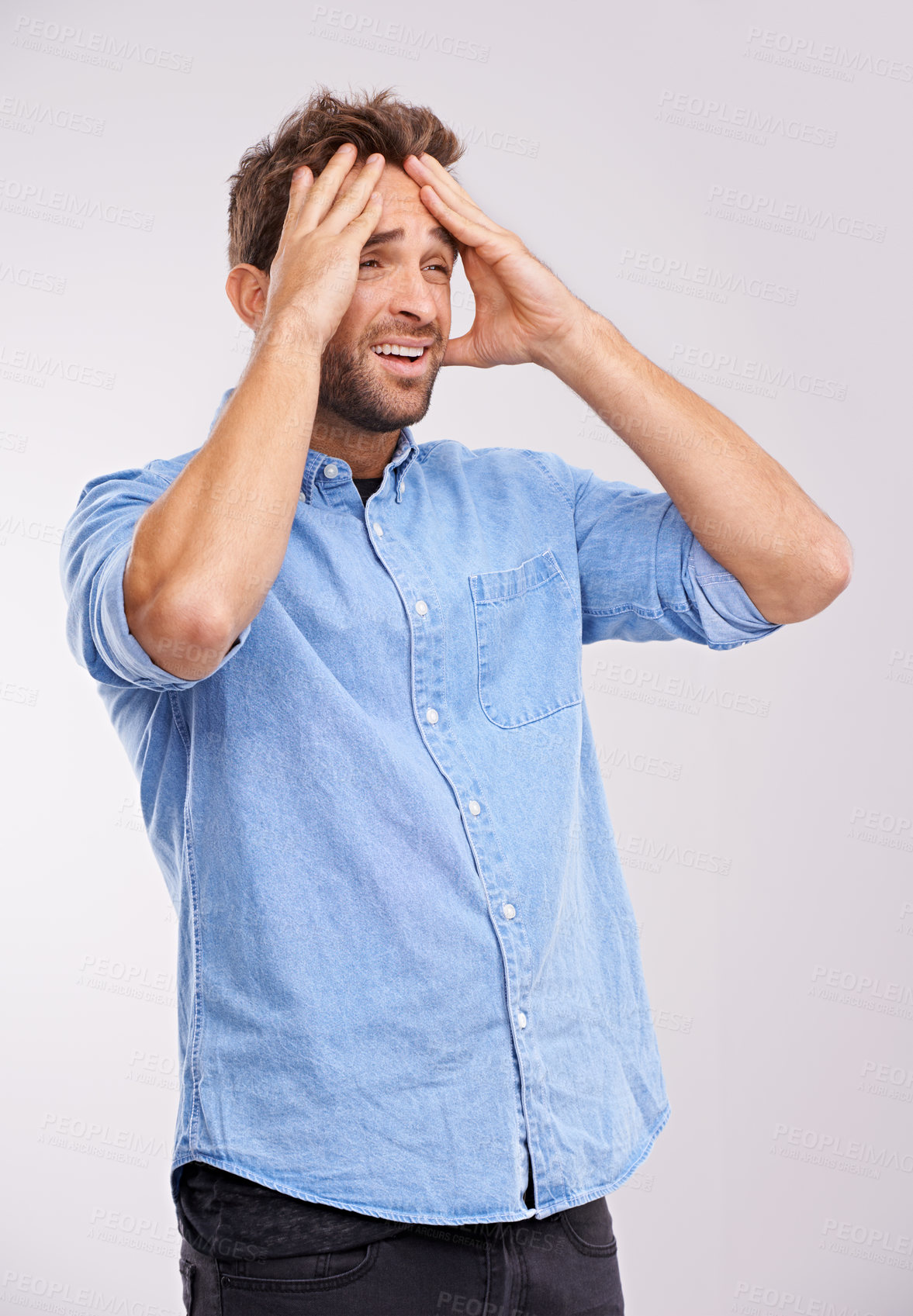 Buy stock photo Studio shot of a handsome young man looking distraught against a gray background