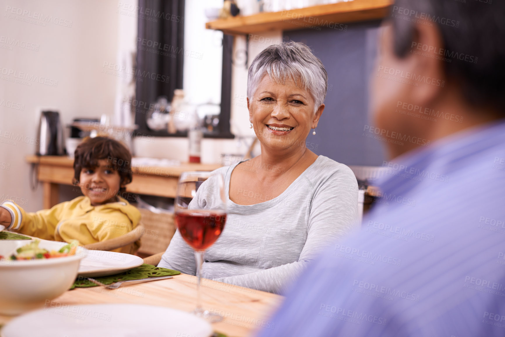Buy stock photo A happy family eating dinner at home
