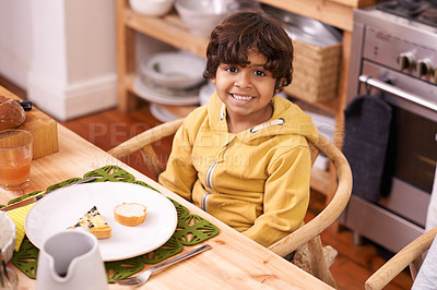 Buy stock photo Happy boy, portrait and relax with meal for dinner, snack or starter in the kitchen at home. Face of little child or hungry kid with smile in happiness for plate, dish or serving at dining room table