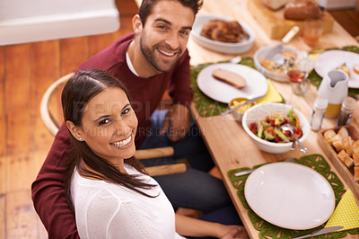 Buy stock photo Smile, dinner and portrait of couple at table with family, food, and drinks for celebration in home. Social event, man and woman at thanksgiving lunch together with high angle, relax and holiday