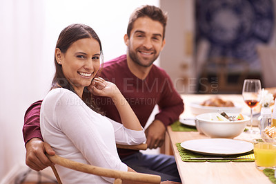 Buy stock photo Happy couple, portrait and dining with food for dinner, romance or family meal together at home. Hungry or young man and woman with smile in relax for snack, eating or support on date by the table