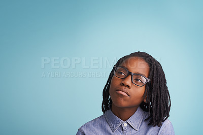 Buy stock photo Glasses, thinking or boy kid in studio with vision, solution or problem solving mockup on blue background. Question, why or African teen model with idea for brainstorming, guess or memory reflection