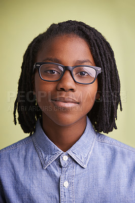 Buy stock photo African teenager, glasses and portrait in studio for education, learning and knowledge on a green background. Face of happy, creative and smart child, boy or student with vision for school in studio