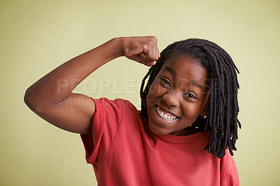 Buy stock photo Studio portrait of a young boy showing off his muscles