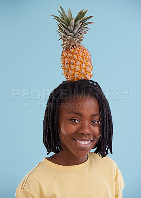 Buy stock photo Portrait, smile and boy child with pineapple in studio for food, wellness or gut health on blue background, Fruit, balance and face of happy African teen model with organic diet, nutrition or detox