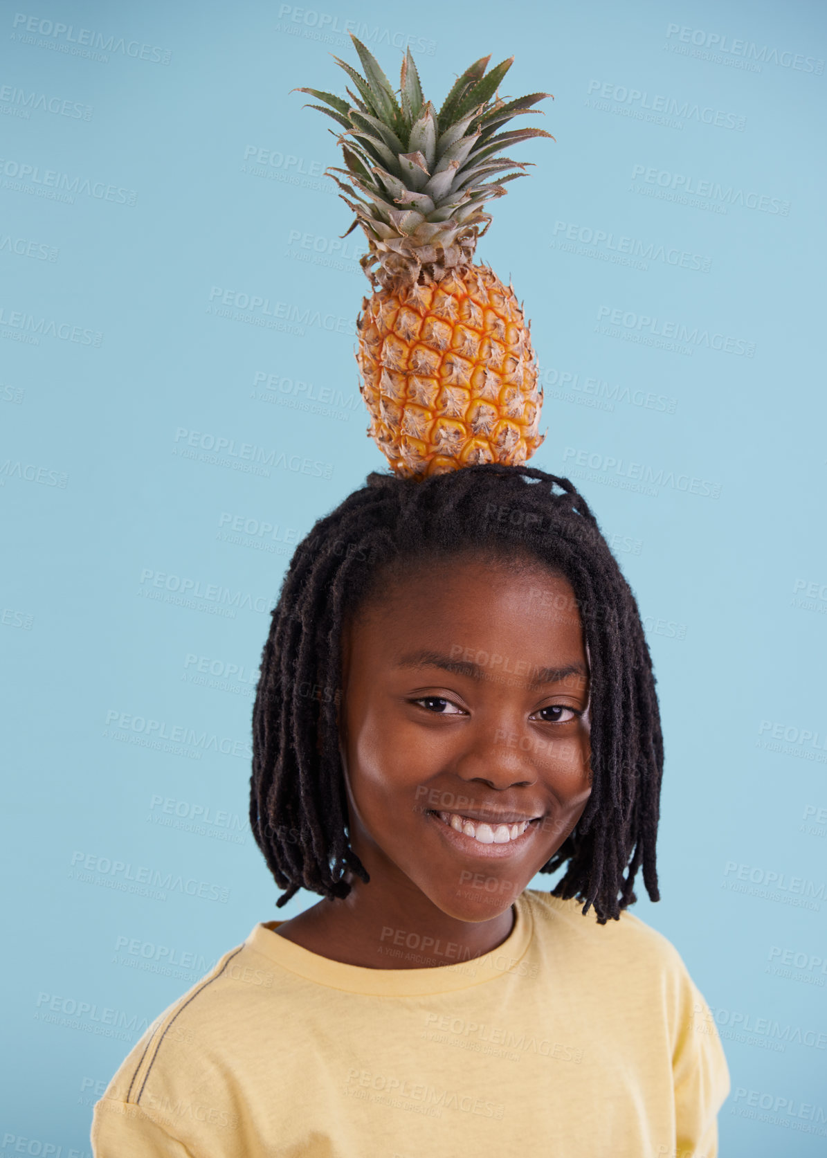 Buy stock photo Portrait, smile and boy child with pineapple in studio for food, wellness or gut health on blue background, Fruit, balance and face of happy African teen model with organic diet, nutrition or detox