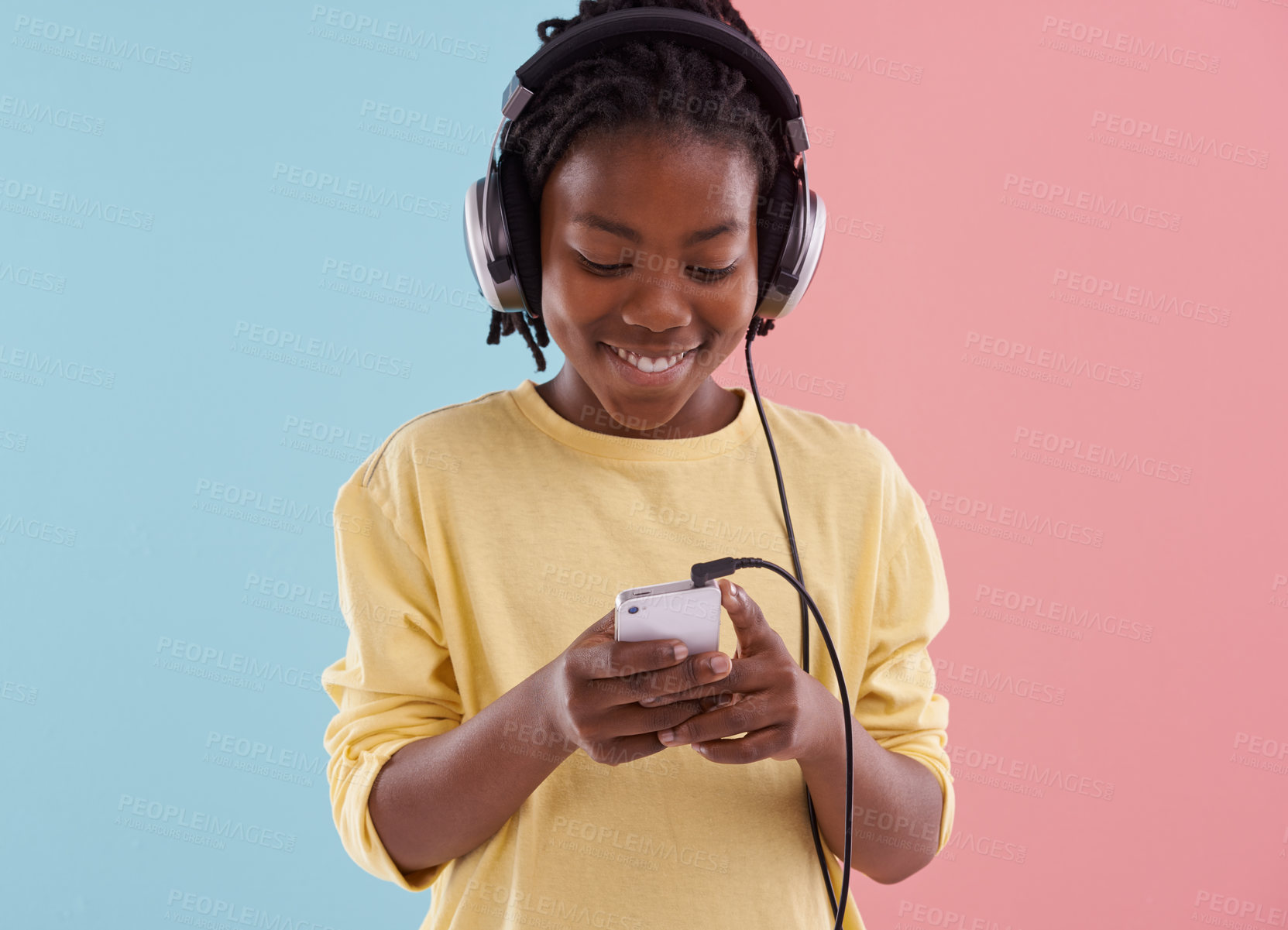 Buy stock photo Teen, relax and boy with phone and headphones in studio for listening to music in high school and reading. Happy, kid and writing creative post on social media with audio or watch live stream on app