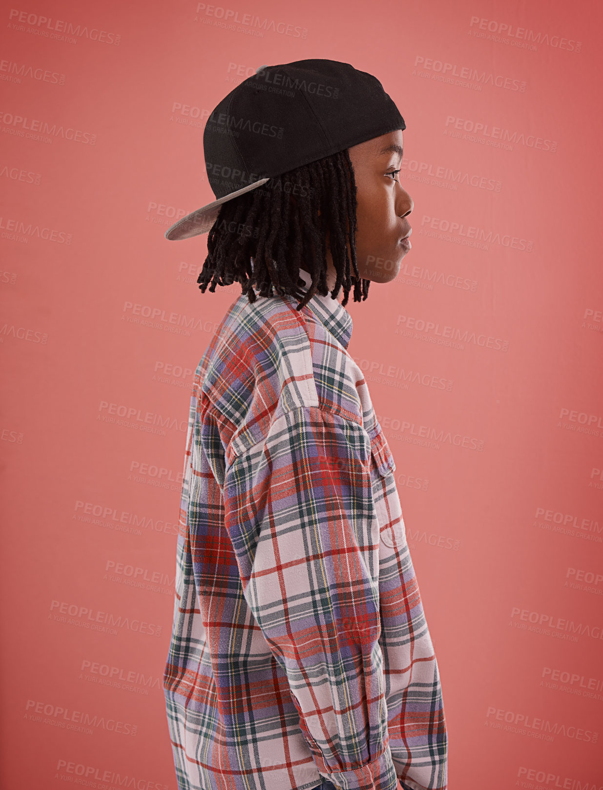 Buy stock photo Boy, fashion or black child with cap in studio for confidence, style or streetwear aesthetic on red background. Face, profile or African teen male model with cool, clothes or trendy outfit choice