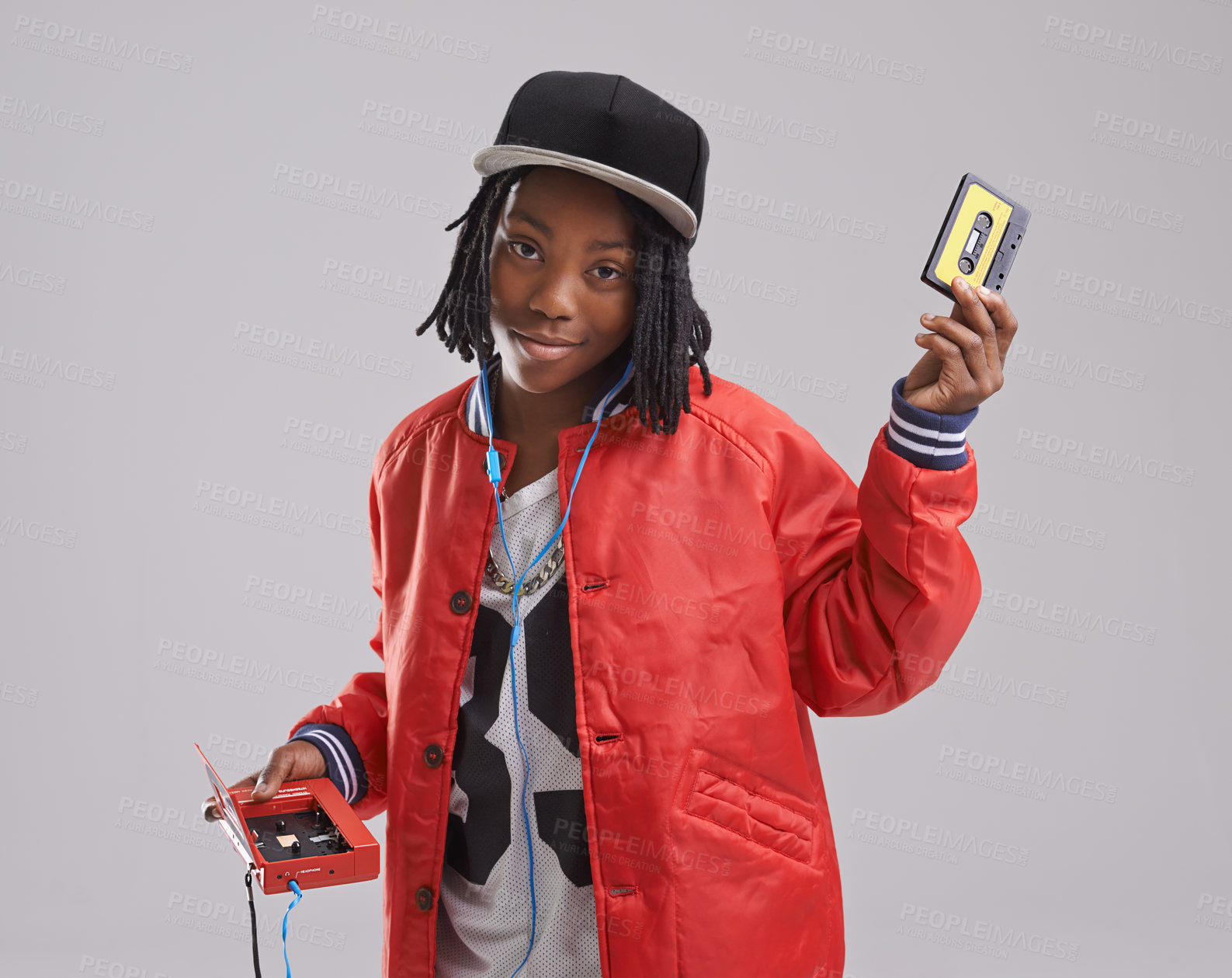 Buy stock photo Music, portrait and child on gray background with cassette for listening to song, audio and radio. Fashion, youth and young African boy with retro tech for track playlist in trendy clothes in studio