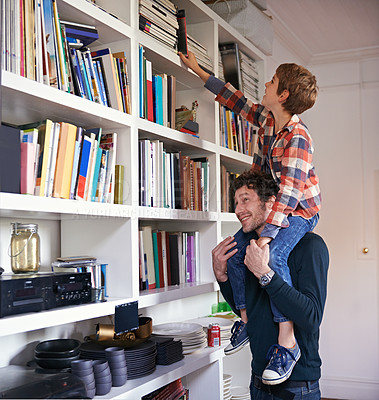 Buy stock photo Dad, boy and shoulders by bookshelf in home for help, lift and think for choice with learning. Father, child and decision for book, support or happy for education, language or reading in family house