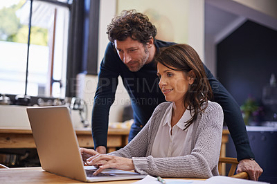 Buy stock photo Shot of a young couple doing their finances at home