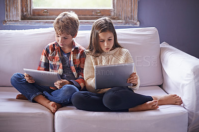 Buy stock photo Young boy, girl and tablet for gaming on sofa together, technology and online streaming for bonding at home. Digital 
world, internet with kids or siblings in living room, gamer app and entertainment