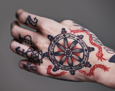 Buy stock photo Person, hands and tattoo for creative and ink for design, picture and symbol for red on closeup. Art, bold and cool for black and statement for funky, trendy and vibrant for unique, edgy and artistic
