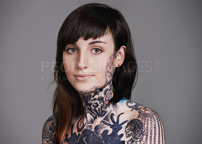 Buy stock photo A cropped studio portrait of a tattooed young woman