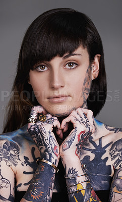 Buy stock photo Woman, portrait and body art with tattoo for style or facial treatment on a gray studio background. Face of female person, brunette or model with design, creativity or cool artist in beauty styling