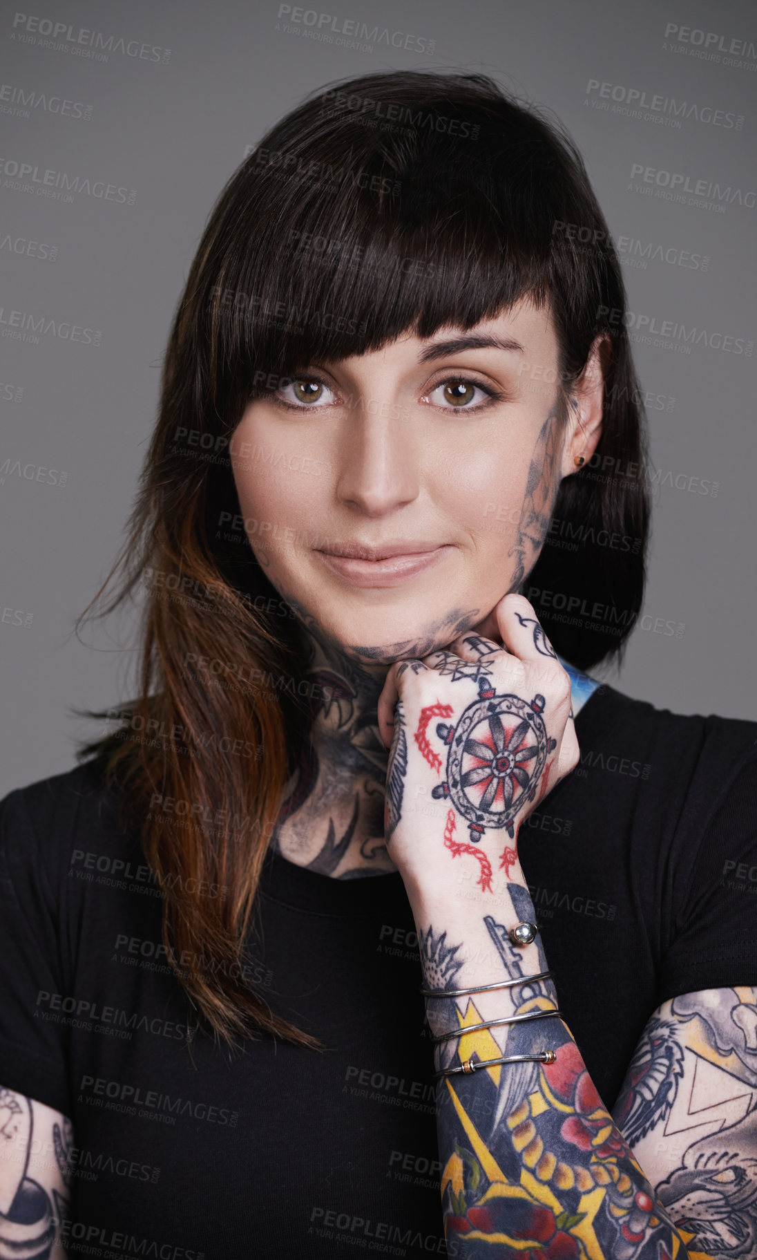 Buy stock photo A cropped studio portrait of a tattooed young woman