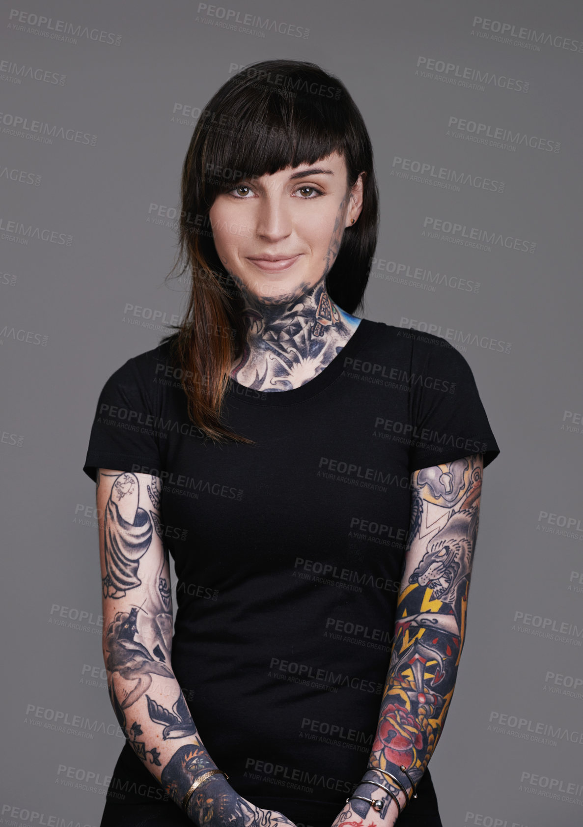 Buy stock photo A cropped studio portrait of a beautiful tattooed young woman