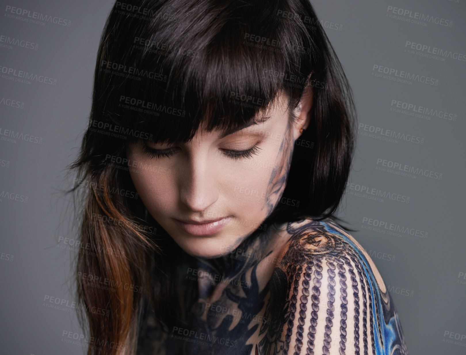 Buy stock photo Woman, tattoo and design for creativity in studio with creative ink, trendy and body art with color. Female person, funky and edgy with artistic or blue for bold statement in gray background
