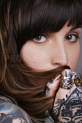 Buy stock photo A cropped studio portrait of a beautiful tattooed young woman