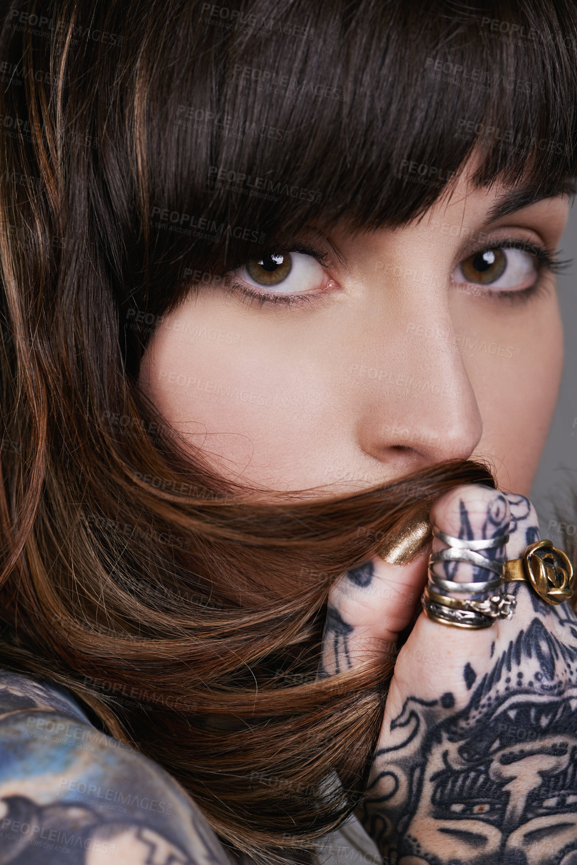 Buy stock photo A cropped studio portrait of a beautiful tattooed young woman