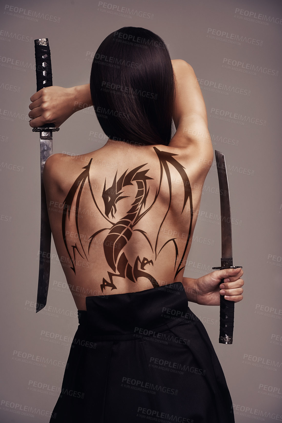 Buy stock photo Woman, sword and dragon tattoo on back isolated on grey background and samurai art culture in Japan. Ninja cosplay, girl warrior or martial arts fighter with swords and creative tattoos in studio.
