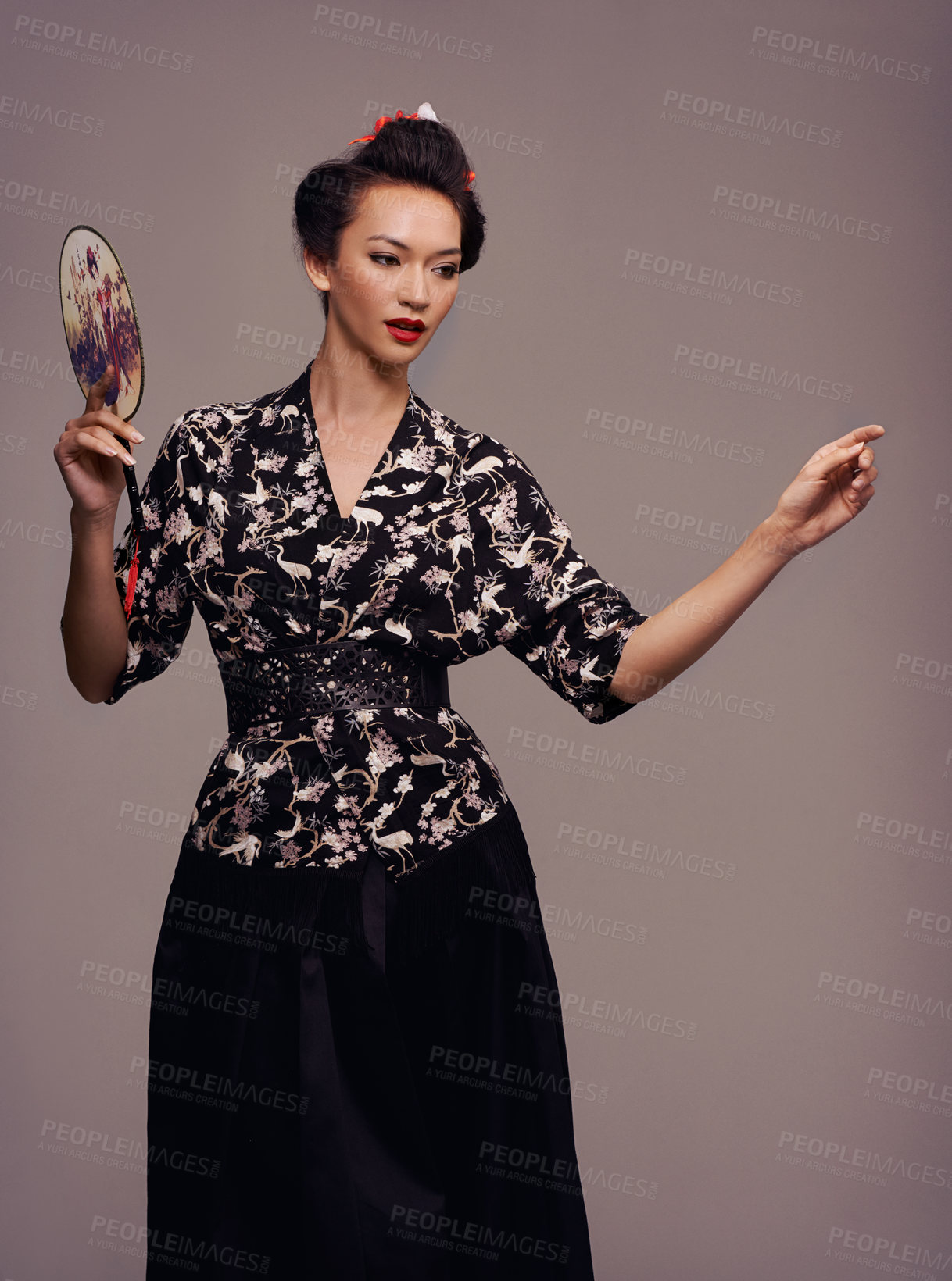Buy stock photo Studio shot of an attractive young woman dressed in traditional asian clothing