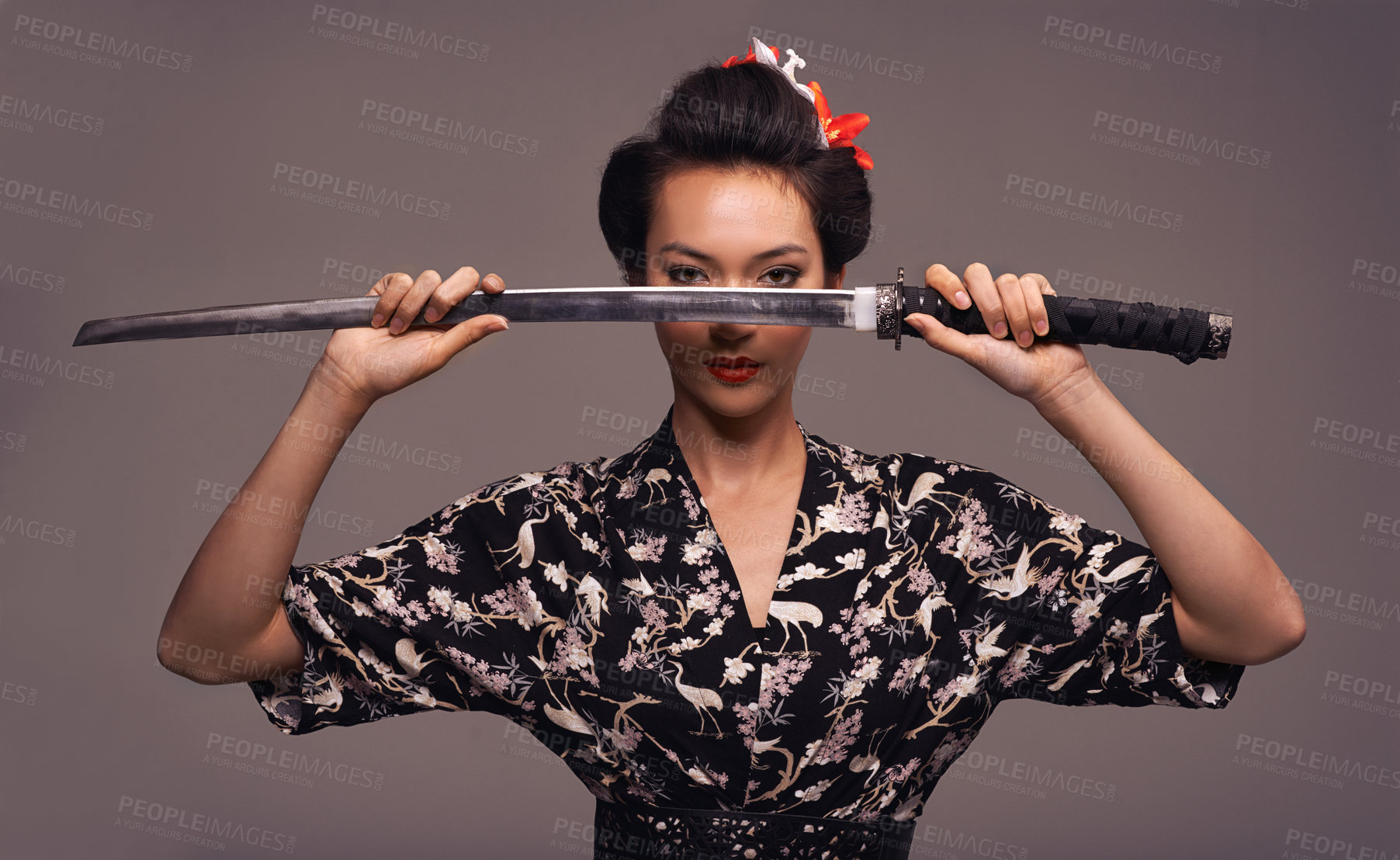 Buy stock photo Studio shot of an attractive young woman holding a samurai sword