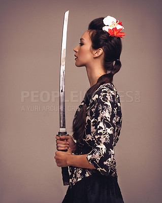 Buy stock photo Asian woman, fashion and confident with sword in studio on brown background in traditional style and elegant. Japanese, female person and cultural with designer clothes or outfit for heritage