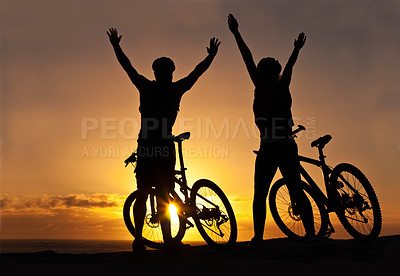 Buy stock photo Silhouette of a couple with their bicycles on the beach