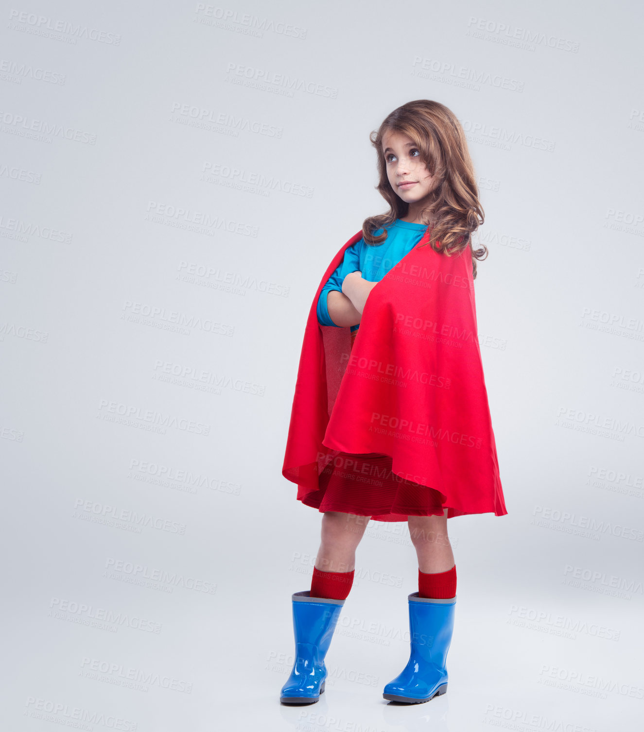 Buy stock photo Girl in superhero costume isolated on a white background in creative cosplay, halloween and character design. Child or kid thinking in super hero clothes or red and blue avatar dress in studio mockup