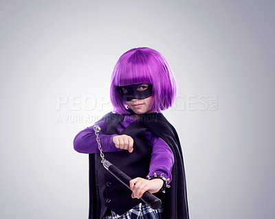 Buy stock photo Kid, costume girl or vigilante in studio portrait with nunchaku, fantasy or creative comic clothes. Kid, superhero aesthetic, mask and creative for martial arts, villain or cosplay by gray background