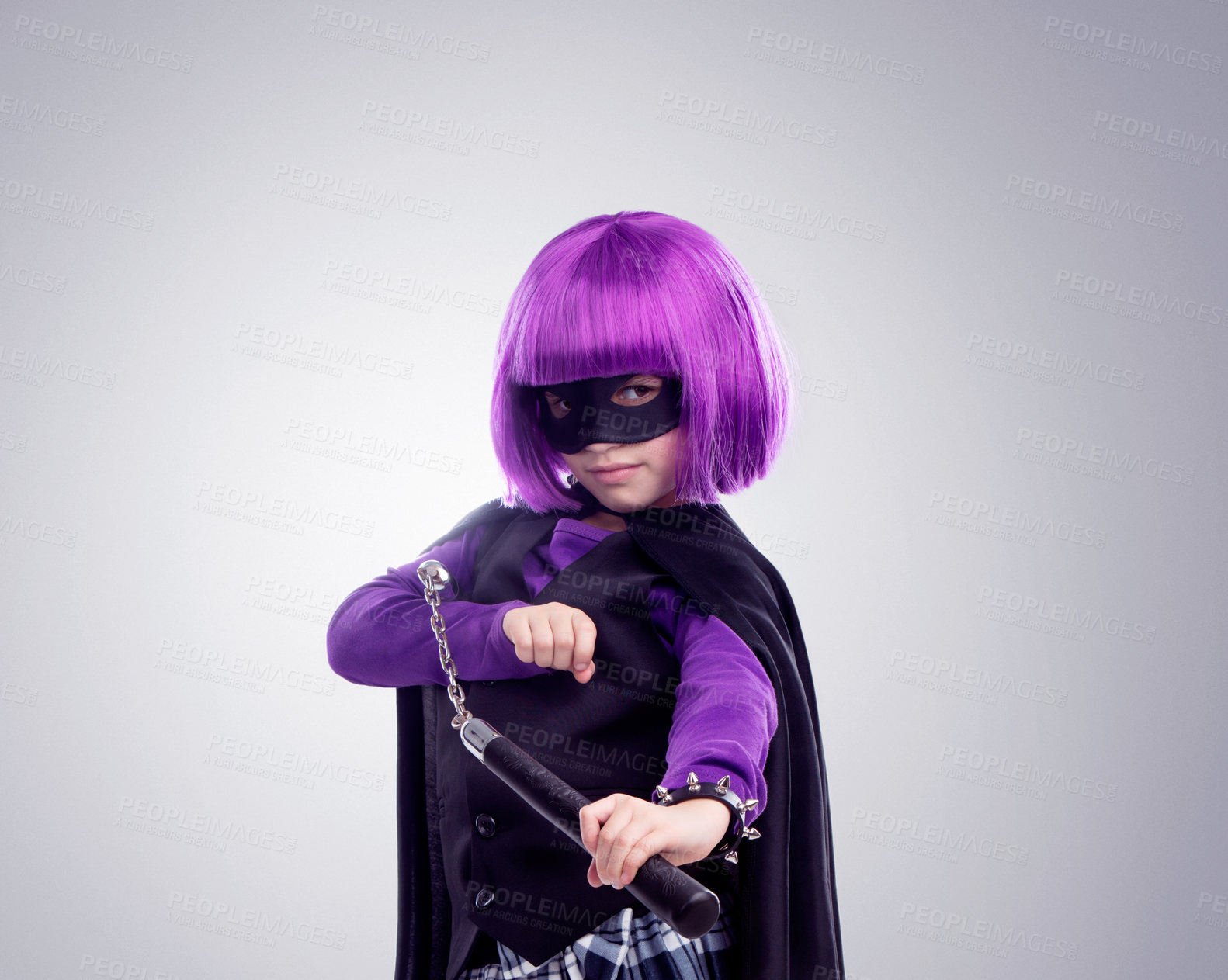 Buy stock photo Kid, costume girl or vigilante in studio portrait with nunchaku, fantasy or creative comic clothes. Kid, superhero aesthetic, mask and creative for martial arts, villain or cosplay by gray background