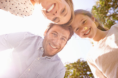 Buy stock photo Nature portrait, blue sky and happy family love of child, mother and father bonding in park, forest or outdoor woods. Freedom, happiness or below view of mama, papa and kid smile for natural sunshine
