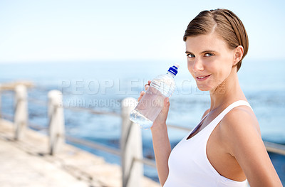 Buy stock photo Woman, water bottle and outdoor at beach for health, fresh air and fitness in nature, h2o and sea. Nutrition, detox and liquid for thirst, hydration and exercise in portrait with drink for wellness 