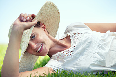 Buy stock photo Woman, relax and portrait on grass with hat, fashion and happiness outdoor at park in nature on holiday. Summer, vacation and girl with style smile on lawn with pride and confidence in garden