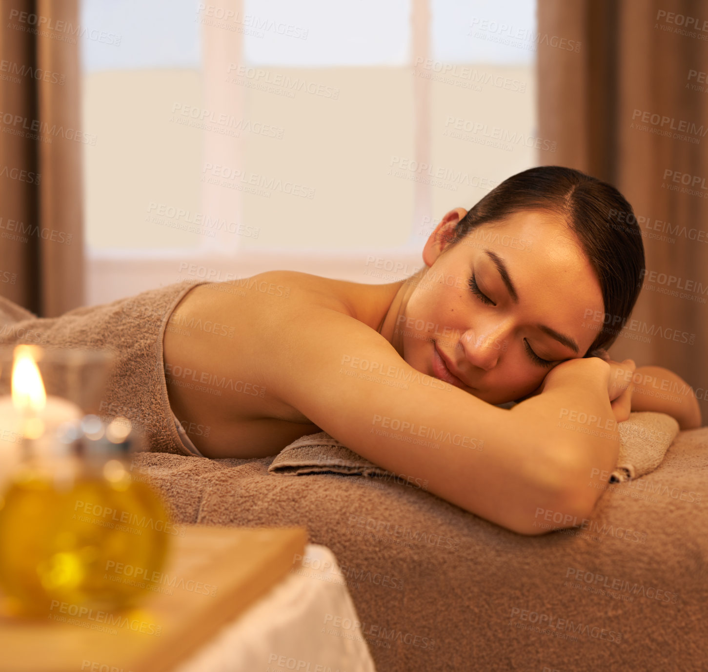 Buy stock photo Peace, sleep and woman on massage table at spa for self care, stress relief and natural wellness. Female person, zen and calm at luxury hotel for body health, hospitality and spiritual healing